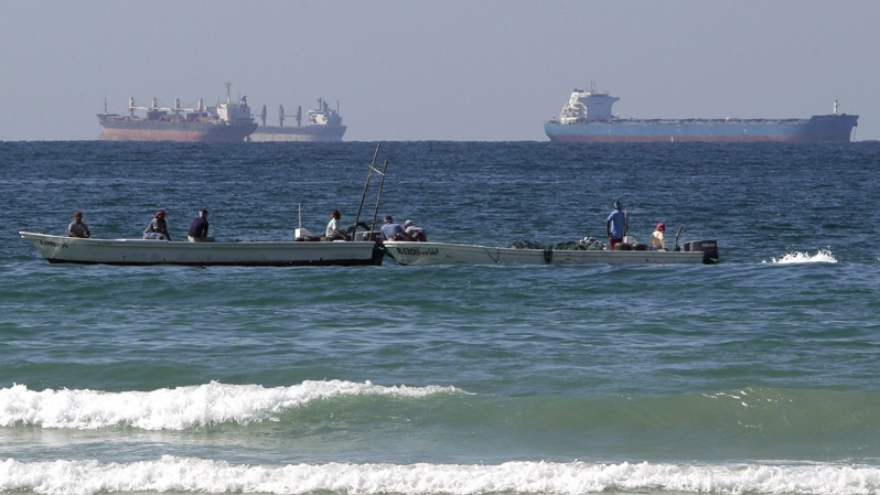 In this Jan. 19, 2012 file photo, fishing boats are seen in front of oil tankers on the Persian Gulf waters, south of the Strait of Hormuz, offshore the town of Ras Al Khaimah in United Arab Emirates.