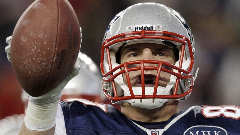 New England Patriots tight end Rob Gronkowski holds up the football after scoring a 12-yard touchdown pass during the first half of an NFL divisional playoff football game against the Denver Broncos Saturday, Jan. 14, 2012, in Foxborough, Mass. (AP Photo/Stephan Savoia) 