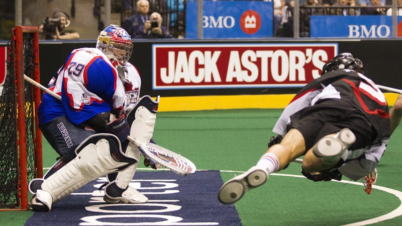 Toronto Rock goaltender Bob Watson makes a save on Washinton Stealth's Paul Rabil (right) in the National Lacrosse League championship game in Toronto on Sunday May 15, 2011. 