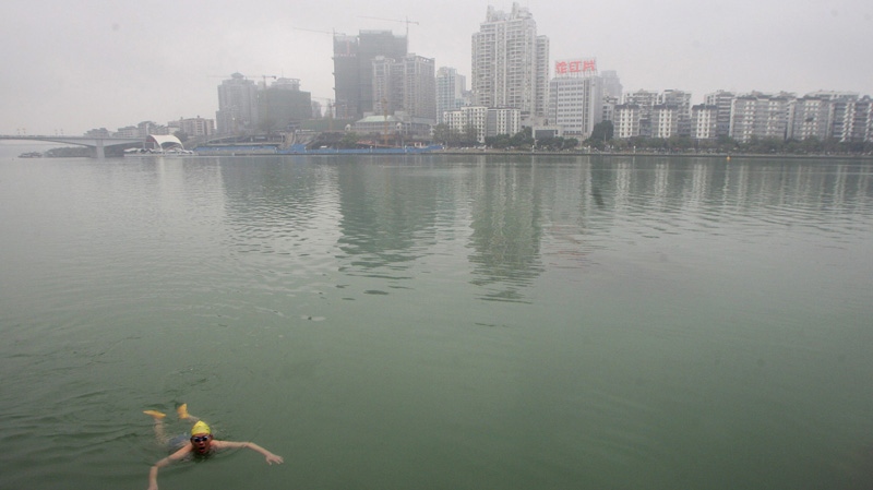 A man swims in Liujiang River in Liuzhou city, in southwestern China's Guangxi region, Friday, Jan. 27, 2012. (AP Photo)
