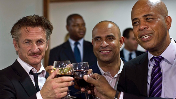 Actor Sean Penn, right, and Haiti's President Michel Martelly, shake hands as they pose for pictures after a special ceremony at the national palace in Port-au-Prince, Haiti, Tuesday, Jan. 31, 2012. (AP / Ramon Espinosa)