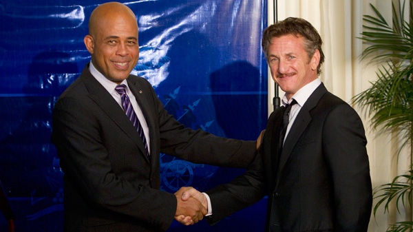Actor Sean Penn, right, and Haiti's President Michel Martelly, shake hands as they pose for pictures after a special ceremony at the national palace in Port-au-Prince, Haiti, Tuesday, Jan. 31, 2012. (AP / Ramon Espinosa)