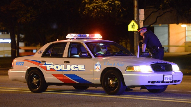 Police investigate the scene where a man was found in the road with serious injuries on Monday, Sept. 1, 2014. (CP24/Andrew Collins)