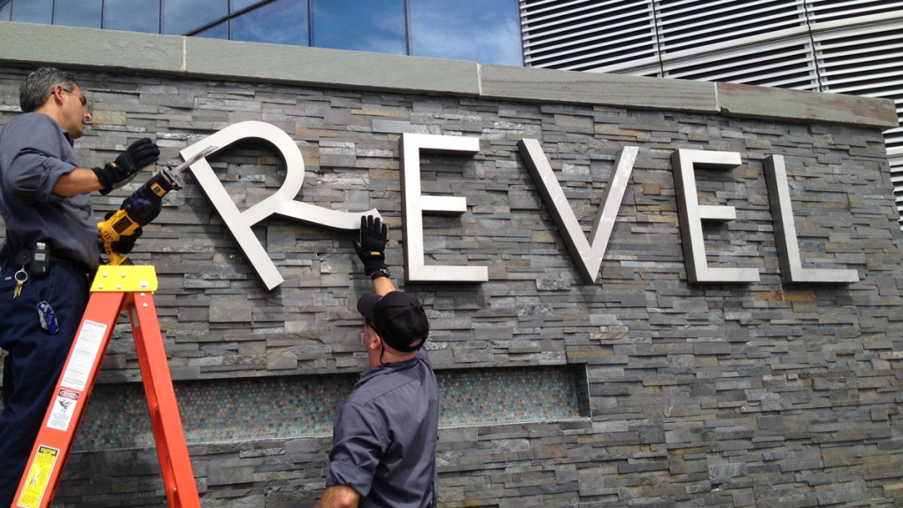 Removing a sign at Revel hotel-casino