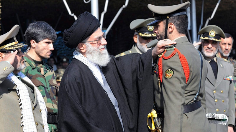 In this photo released by the official website of the Iranian supreme leader's office, Iranian supreme leader Ayatollah Ali Khamenei, center, confers a rank to an unidentified member of Iran's army during a ceremony, in Tehran, Iran, Thursday, Nov. 10, 2011. (Office of the Supreme Leader, File) 