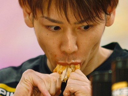 Takeru Kobayashi eats chicken wings during a Major League Eating competition in Las Vegas in this Tuesday, Oct. 9, 2007, photo. (AP Photo/Isaac Brekken)
