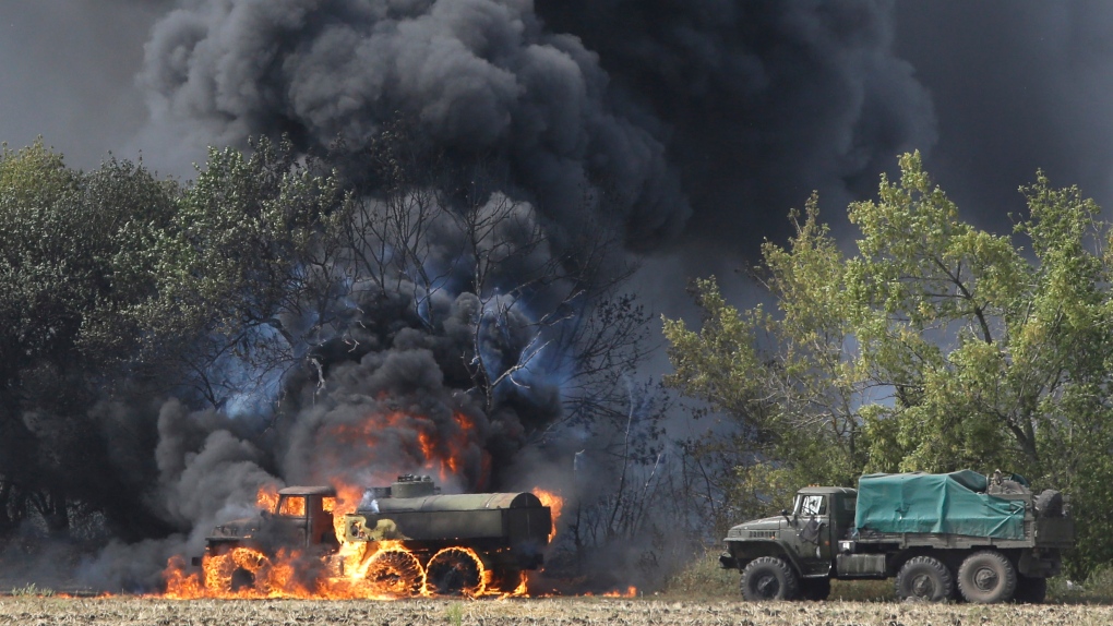Unmarked military vehicles burn