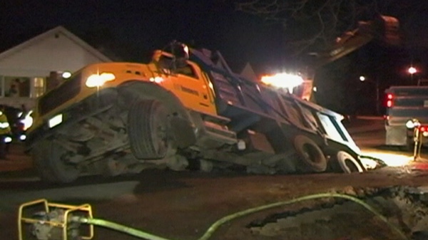 A city truck lies stuck in a sinkhole on Barbara Crescent in East York on Thursday, Feb. 2, 2012.