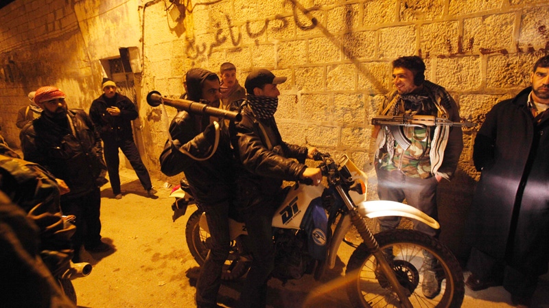 Syrian rebels gather in an alley as they secure a demonstration in Idlib, Syria, Sunday, Feb. 5, 2012. (AP Photo)