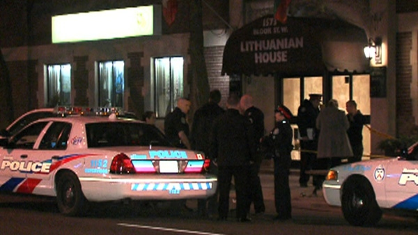 Officers gather outside the Lithuanian House on Bloor Street West and Dundas Street West following a stabbing, Sunday, Feb. 5, 2012.