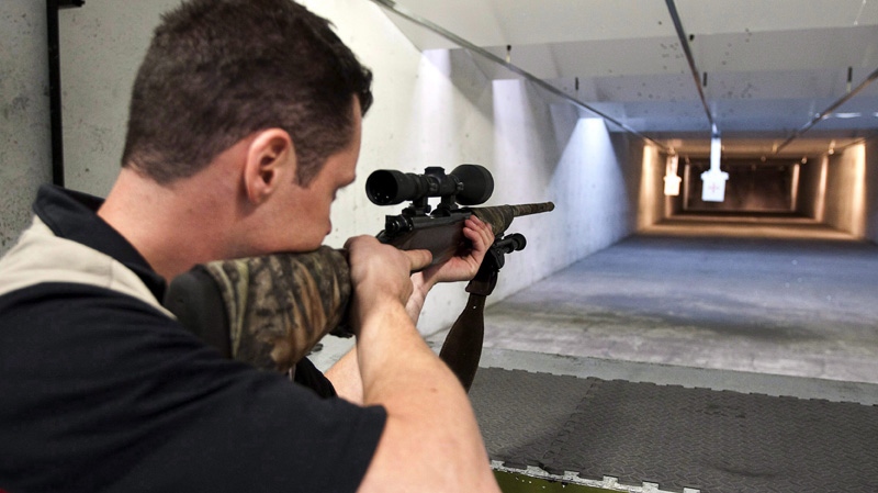 In this Sept. 15, 2010 photo, range officer Patrick Deegan aims a long gun at a private range in Calgary. (THE CANADIAN PRESS/Jeff McIntosh)