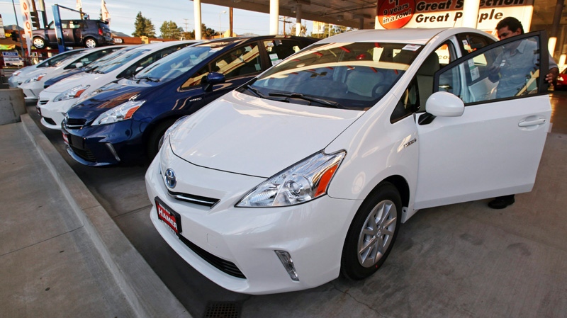 An employee parks a Toyota gas-electric hybrid automobile in a row of similar cars at a dealership in Los Angeles, Thursday, Jan. 26, 2012. (AP / Reed Saxon)