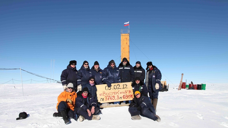 In this Monday, Feb. 5, 2012 photo provided by Arctic and Antarctic Research Insitute of St. Petersburg, Russian researchers at the Vostok station in Antarctica pose for a picture after reaching subglacial lake Vostok. Scientists hold the sign reading "05.02.12, Vostok station, boreshaft 5gr, lake at depth 3769.3 metres." (AP Photo/Arctic and Antarctic Research Institute Press Service)