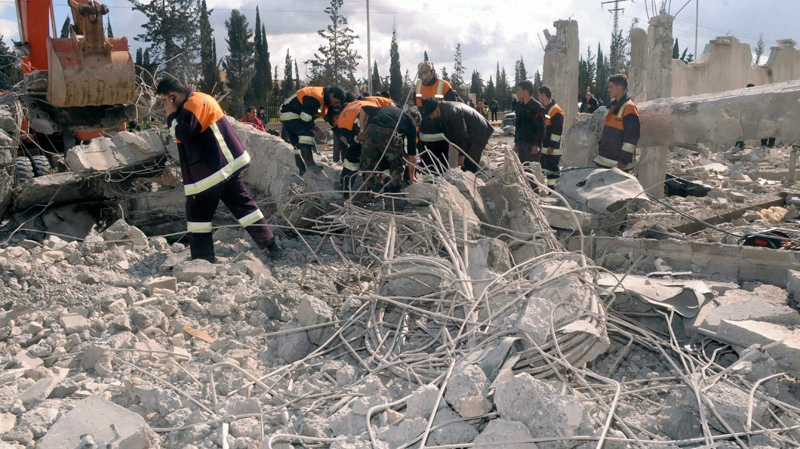 In this photo released by the Syrian official news agency SANA, Syrian rescue workers remove wreckage from a destroyed building at a security compound which was attacked by an explosion, in the northern city of Aleppo, Syria, on Friday, Feb. 10, 2012. (SANA)