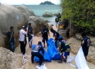 Thai officers work near the bodies of two British tourists, on a beach in Surat Thani province, southern Thailand, Monday, Sept. 15, 2014. (AP / Daily News)