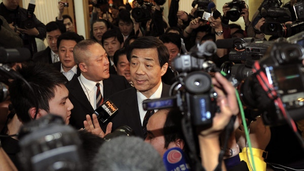Bo Xilai, center, party secretary of the western city of Chongqing, is surrounded by members of the media upon arrival at the National People's Congress at the Great Hall of the People in Beijing in this March 6, 2010 file photo. (AP Photo/Andy Wong)