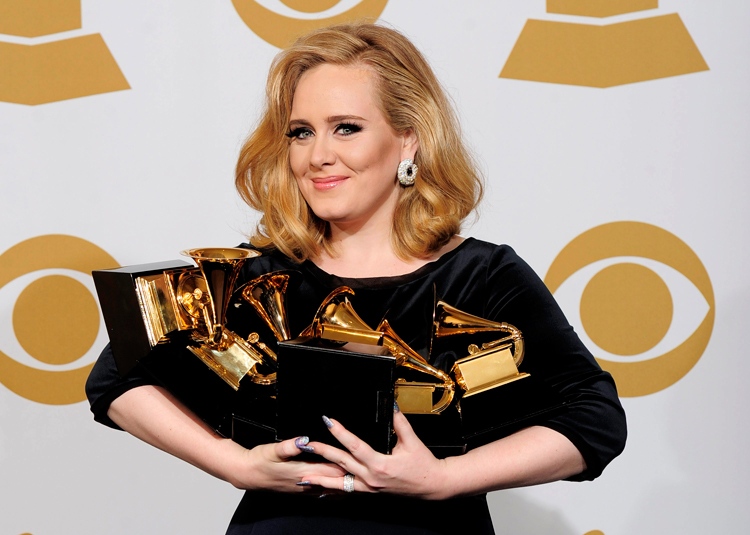 Adele poses backstage with her six awards at the 54th annual Grammy Awards on Sunday, Feb. 12, 2012 in Los Angeles. (AP / Mark J. Terrill)