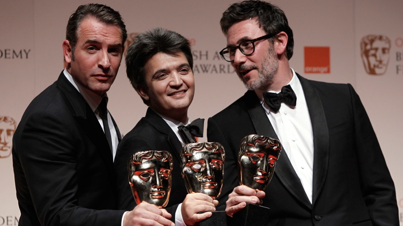 Actor Jean Dujardin, producer Thomas Langmann and director Michel Hazanavicius with the awards for 'Best Leading Actor, Best Film and Best Director' all for the film 'The Artist' backstage at the BAFTA Film Awards 2012, at The Royal Opera House in London, Sunday, Feb. 12, 2012. (AP / Joel Ryan)