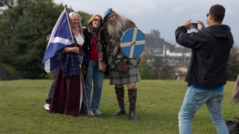 Members of a Scottish historical re-enactment group wearing historical Scottish outfits pose for photographs on Calton Hill, in Edinburgh, Scotland, on Sept. 16, 2014. (AP / Matt Dunham)