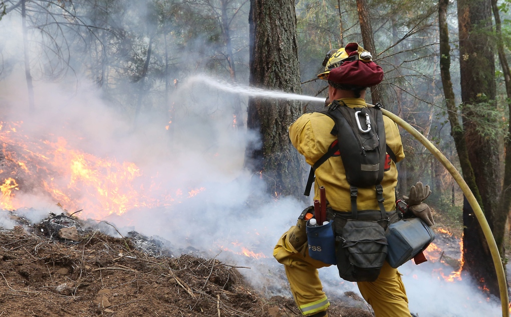 Firefighter waters flames in California