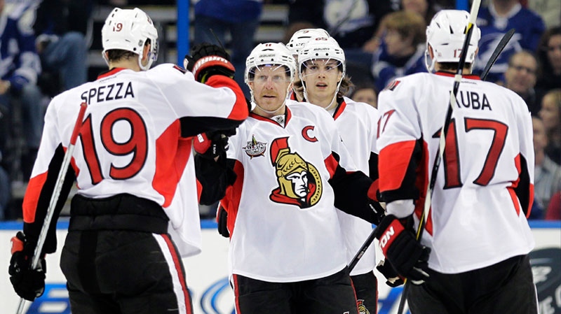 Ottawa Senators right wing Daniel Alfredsson, center, of Sweden, celebrates Jason Spezza's (19) goal against the Tampa Bay Lightning with Filip Kuba (17) during the second period of an NHL hockey game, Tuesday, Feb. 14, 2012, in Tampa, Fla. (AP Photo/Chris O'Meara)