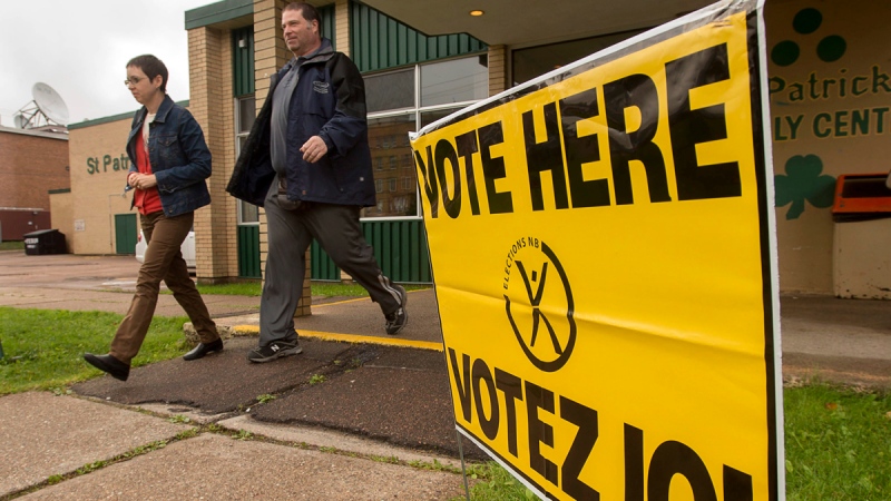 Voters head from a polling station after casting their ballot in the New Brunswick provincial election in Moncton, N.B. on Monday, Sept. 22, 2014. (THE CANADIAN PRESS / Andrew Vaughan)