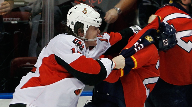 Ottawa Senators' Zack Smith (15) brawls with Florida Panthers' Tyson Strachan (23) in the third period of an NHL hockey game in Sunrise, Fla., Wednesday, Feb. 15, 2012. The Senators won 6-2. (AP Photo/Alan Diaz)