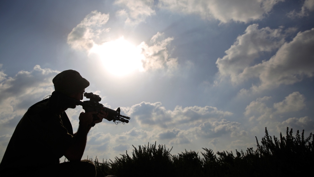 Israeli soldier looks toward Gaza
