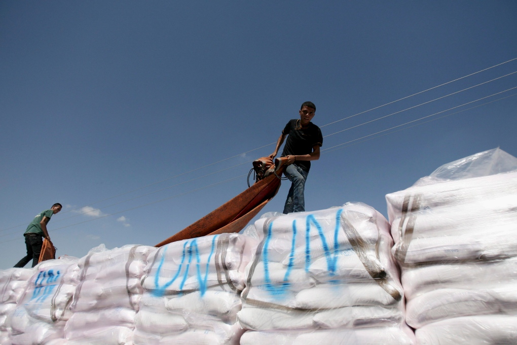 Palestinian workers check aid truck