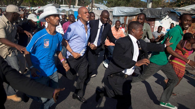Haiti's President Michel Martelly, third from left, jogs around the University of Haiti protected by bodyguards in Port-au-Prince, Haiti, Friday, Feb. 17, 2012. (AP / Ramon Espinosa)