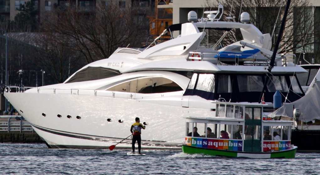 Water taxi passes yacht in Vancouver