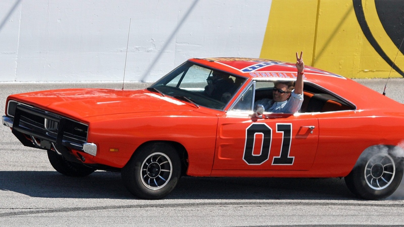 John Schnieder star of the 'The Dukes of Hazzard,' waves from the General Lee before the Kobalt Tools 500 auto race Sunday, March 9, 2008, in Atlanta. (AP / Dale Davis)