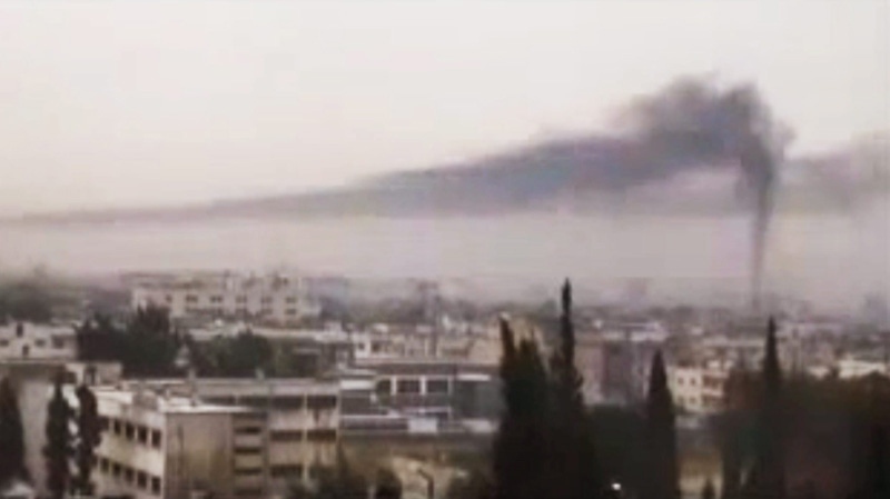 This image from amateur video made available by Shaam News Network, purports to show black smoke rising in the air in Homs, Syria, Thursday, Feb. 16, 2012.(AP Photo/Shaam News Network via APTN)