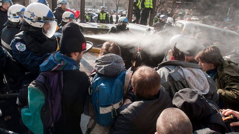 Police use pepper spray to disperse a crowd blocking the Delta hotel during a demonstration against higher tuition fees Thursday, February 16, 2012 in Montreal.THE CANADIAN PRESS/Ryan Remiorz
