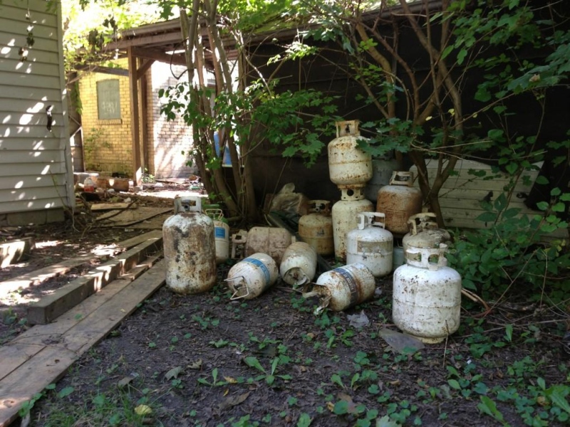 Propane tanks litter the property of an abandoned home on Marmora Street in London, Ont. on Friday, Sept. 26, 2014. (Bryan Bicknell / CTV London)