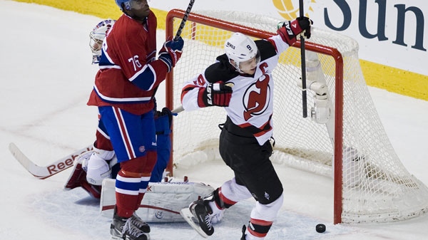 New Jersey Devils' Zach Parise (9) celebrates after scoring against Montreal Canadiens' goaltender Carey Price, left, as Canadiens' P.K. Subban looks on during first period NHL hockey action in Montreal, Sunday, Februay 19, 2012. THE CANADIAN PRESS/Graham Hughes