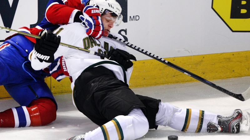 Dallas Stars center Tomas Vincour (81), right, is hauled to the ice by Montreal Canadiens defenseman Alexei Emelin (74) during first period National Hockey League action Tuesday, February 21, 2012 in Montreal.THE CANADIAN PRESS/Ryan Remiorz