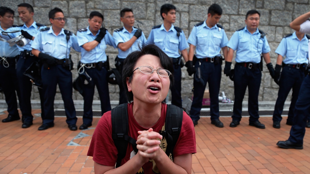 Student protester, police in Hong Kong