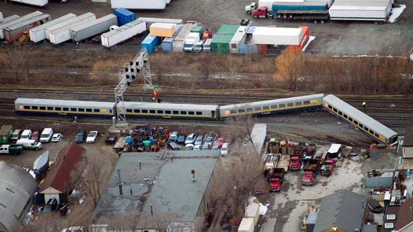 Emergency crews attend the scene where a VIA train was derailed with passengers on board in Burlington, Ont., on Sunday, Feb. 26, 2012. (Nathan Denette / THE CANADIAN PRESS)