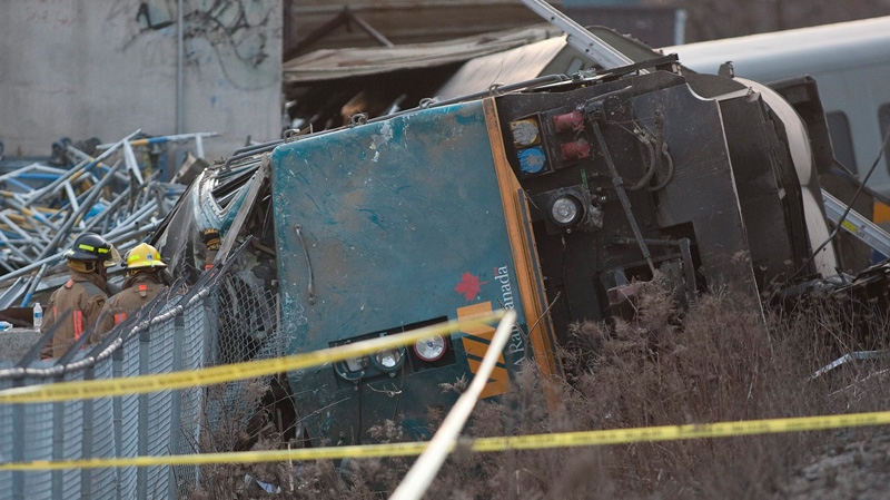 Rescue crews work on a derailed VIA rail train in Burlington, Ontario on Sunday, Feb. 26, 2012. (Pawel Dwulit / THE CANADIAN PRESS)