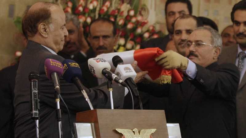 Yemen's former President Ali Abdullah Saleh, right, hands over power to the country's newly-elected President Abed Rabbu Mansour Hadi during a ceremony at the presidential palace in Sanaa, Yemen, Monday, Feb. 27, 2012. (AP Photo/Hani Mohammed)