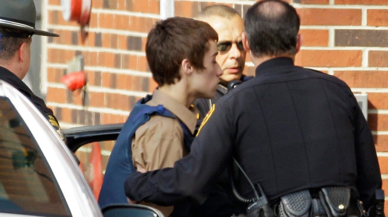 T.J. Lane, a suspect in Monday's shooting of five students at Chardon High School is taken into juvenile court by Geauga County deputies in Chardon, Ohio Tuesday, Feb. 28, 2012.