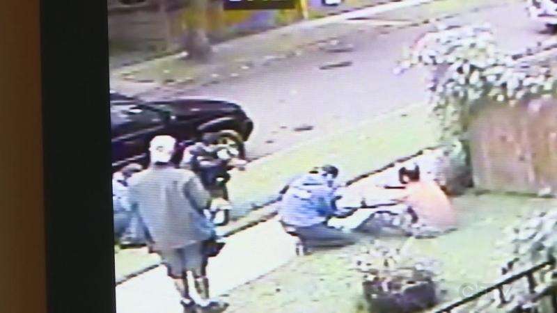 An image taken from surveillance video shows a homeowner, right, recovering after struggling with an intruder in his home as the man is arrested by Windsor police.