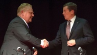 Doug Ford (left) shakes hands with John Tory after taking part in a Toronto Mayoral Debate in Toronto on Tuesday, Sept. 23, 2014. (Chris Young / THE CANADIAN PRESS)