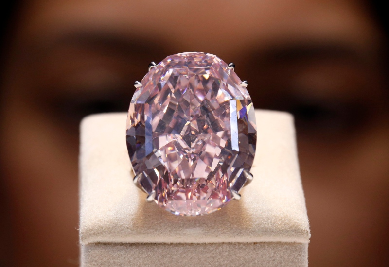 A Hong Kong billionaire tycoon who has been convicted of corruption paid a total of $77 million at auctions in Geneva for two large and rare colored diamonds for his daughter, his office said Thursday. (AP / Vincent Yu)