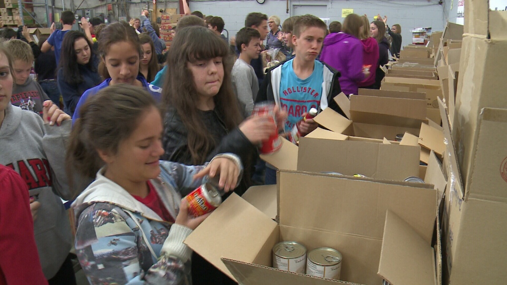 Students from St. Mark High school packing food.