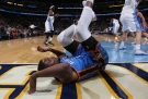 Oklahoma City Thunder forward Kevin Durant ends up on his back on the baseline after his shot was blocked by Denver Nuggets center Timofey Mozgov in the first quarter of an NBA exhibition basketball game in Denver on Wednesday, Oct. 8, 2014. (AP / David Zalubowski)
