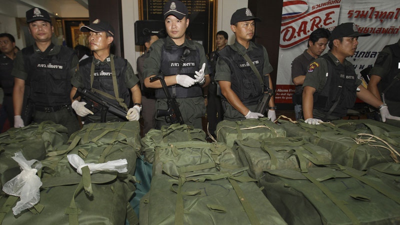 Thai policemen guard packages containing more than 4 million methamphetamine tablets seized in the northern province of Chiang Rai prior to a press conference at Police headquarters in Bangkok, Thailand, Friday, March. 2, 2012. The seizure was one of the biggest ever of the illegal drug, believed to have been produced in neighboring Myanmar, according to a local report.