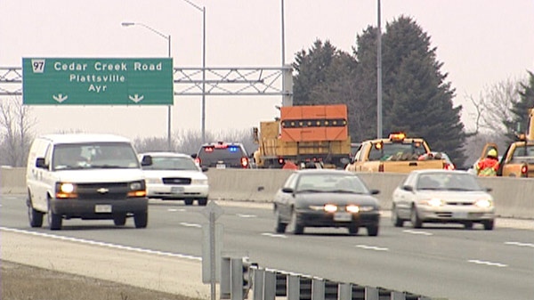 Traffic is diverted off Highway 401 at Cedar Creek Road after a crash near Drumbo, Ont. on Friday, March 2, 2012.