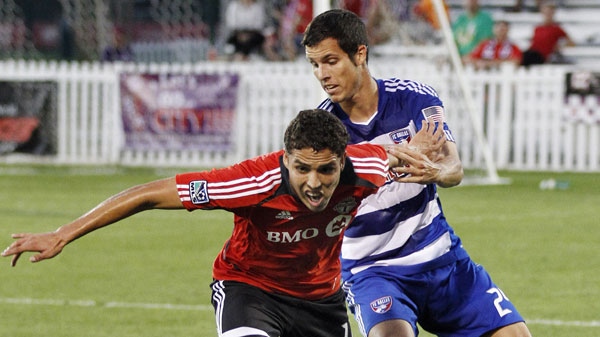FC Dallas' Matt Hedges, right, fights for the ball with Toronto FC's Luis Silva, left, during the first half of a soccer match in the Walt Disney World Pro Soccer Classic, Thursday, March 1, 2012, in Lake Buena Vista, Fla. Toronto FC won 3-0. (AP Photo/Reinhold Matay)